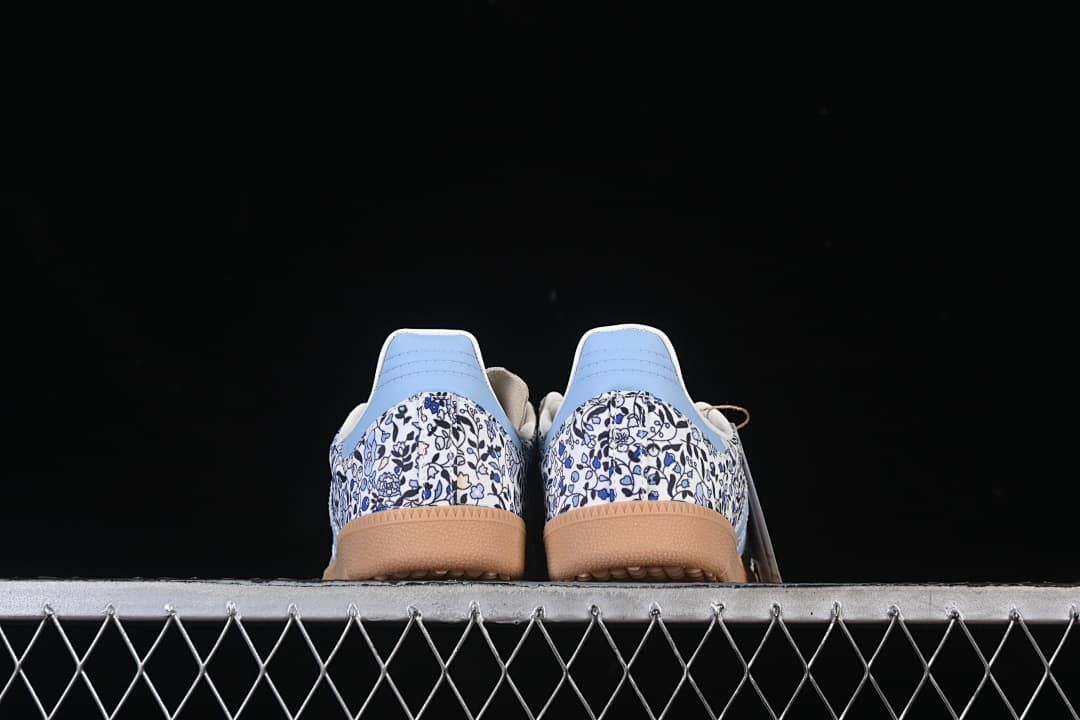Rear view of both sneakers showing floral-print heels and gum-colored soles