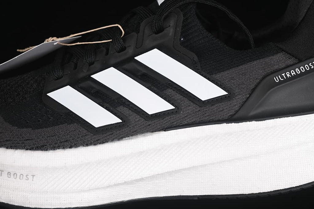 Close-up of the side stripes, knit-look upper, and white midsole