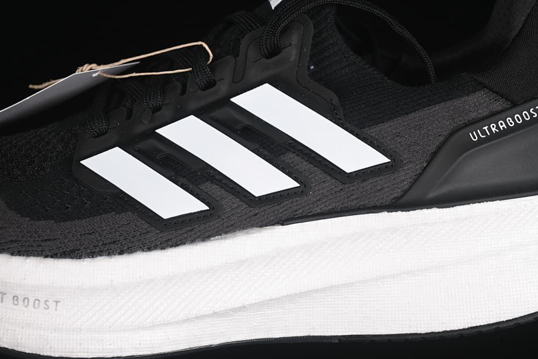 Close-up of the side stripes, knit-look upper, and white midsole