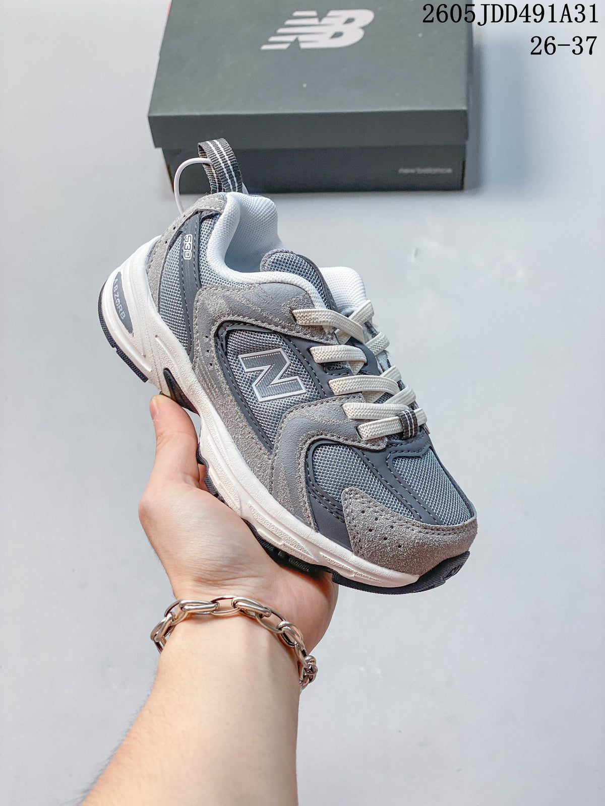 Angled side view of a gray New Balance 530 kids' sneaker