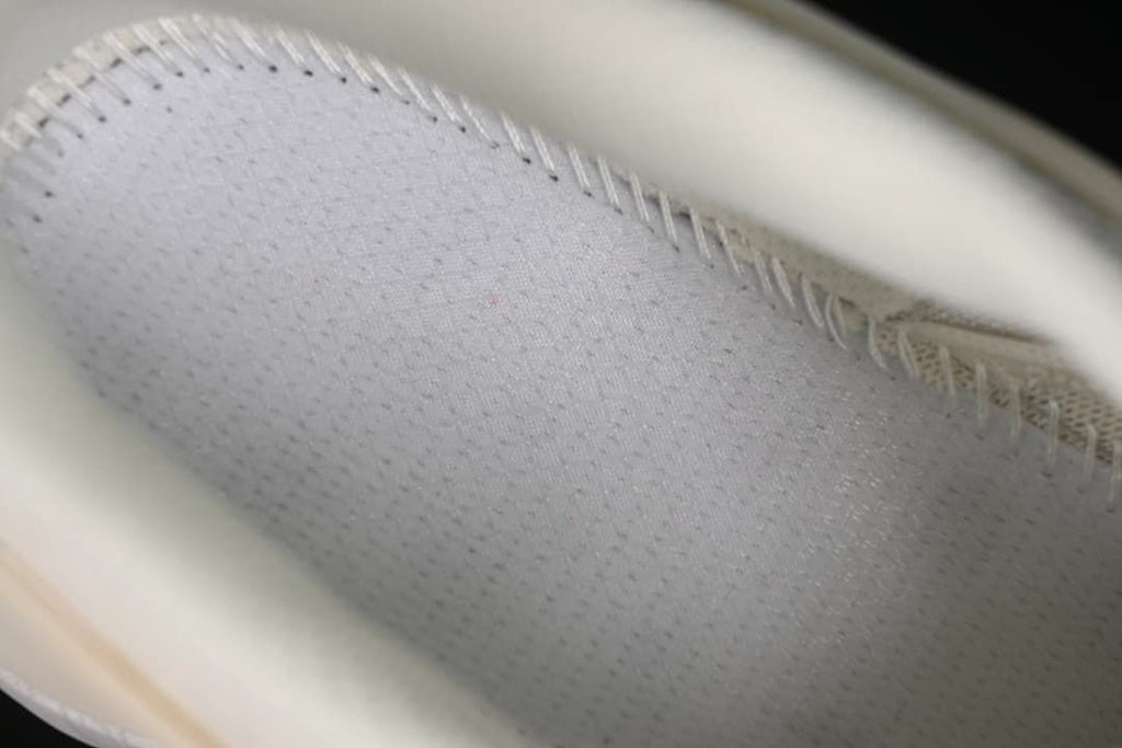 Close-up inside the shoe showing the textile lining and stitching.