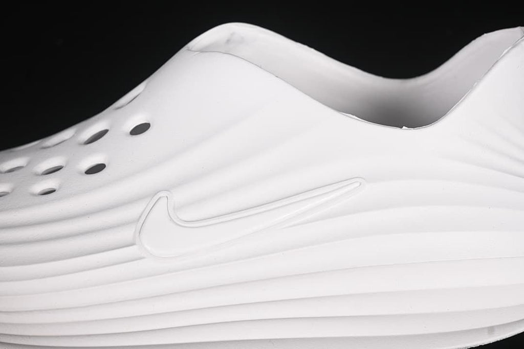 Close-up of perforations and the side logo on the white clog