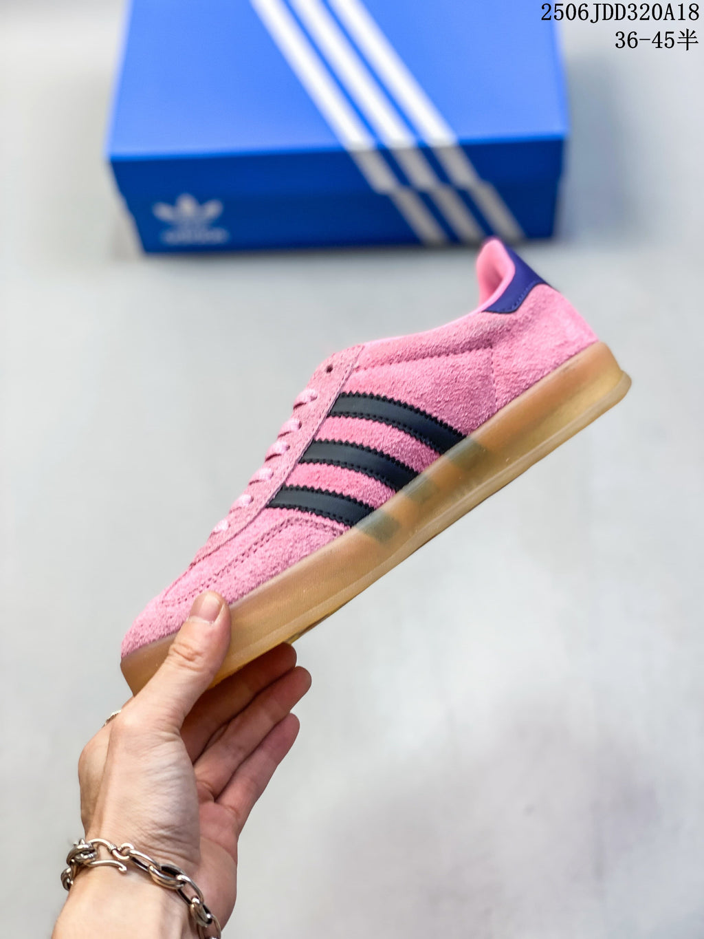 Side profile of a pink low-top sneaker with dark stripes and a gum-look sole.