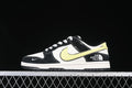 Side view of a black and white low-top sneaker with a pale yellow swoosh and The North Face heel branding.