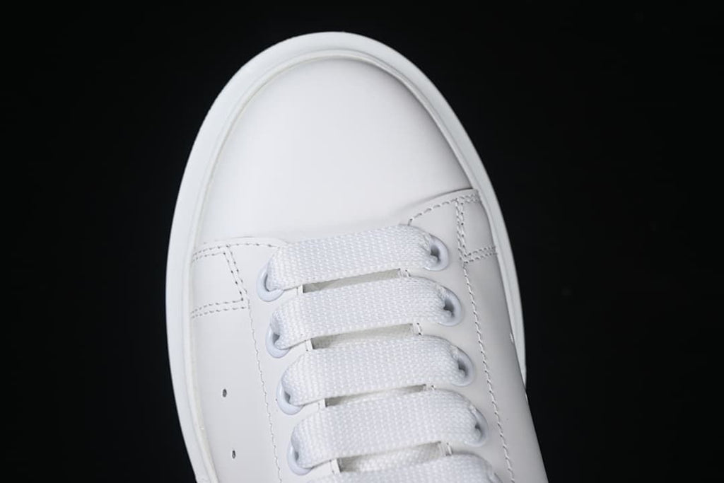 Top-down close-up of the rounded toe and broad white laces.