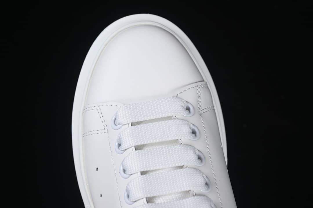 Top-down close-up of the rounded toe and broad white laces.