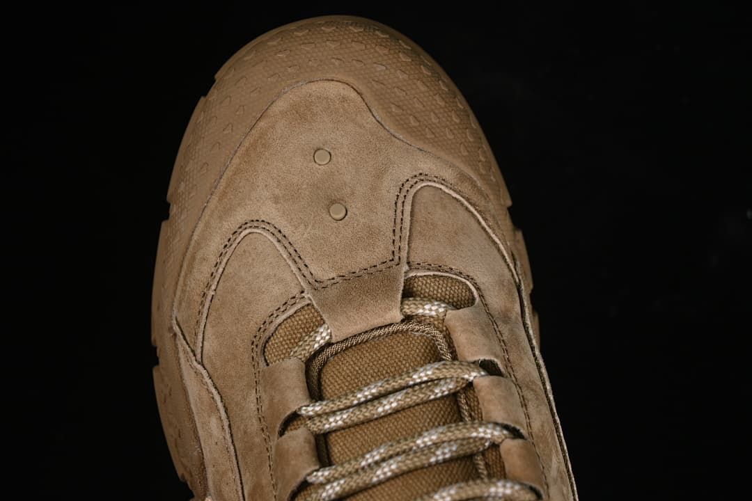 Top view of the sneaker toe, panel stitching, and laces.