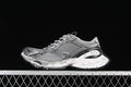 Side view of a grey and silver Balenciaga-style chunky sneaker against a black background