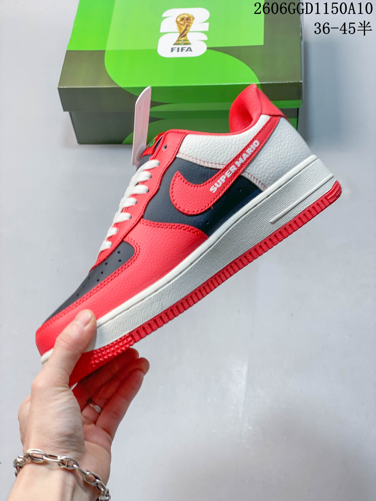 Side profile showing red and navy panels, off-white heel section, and graphic details.