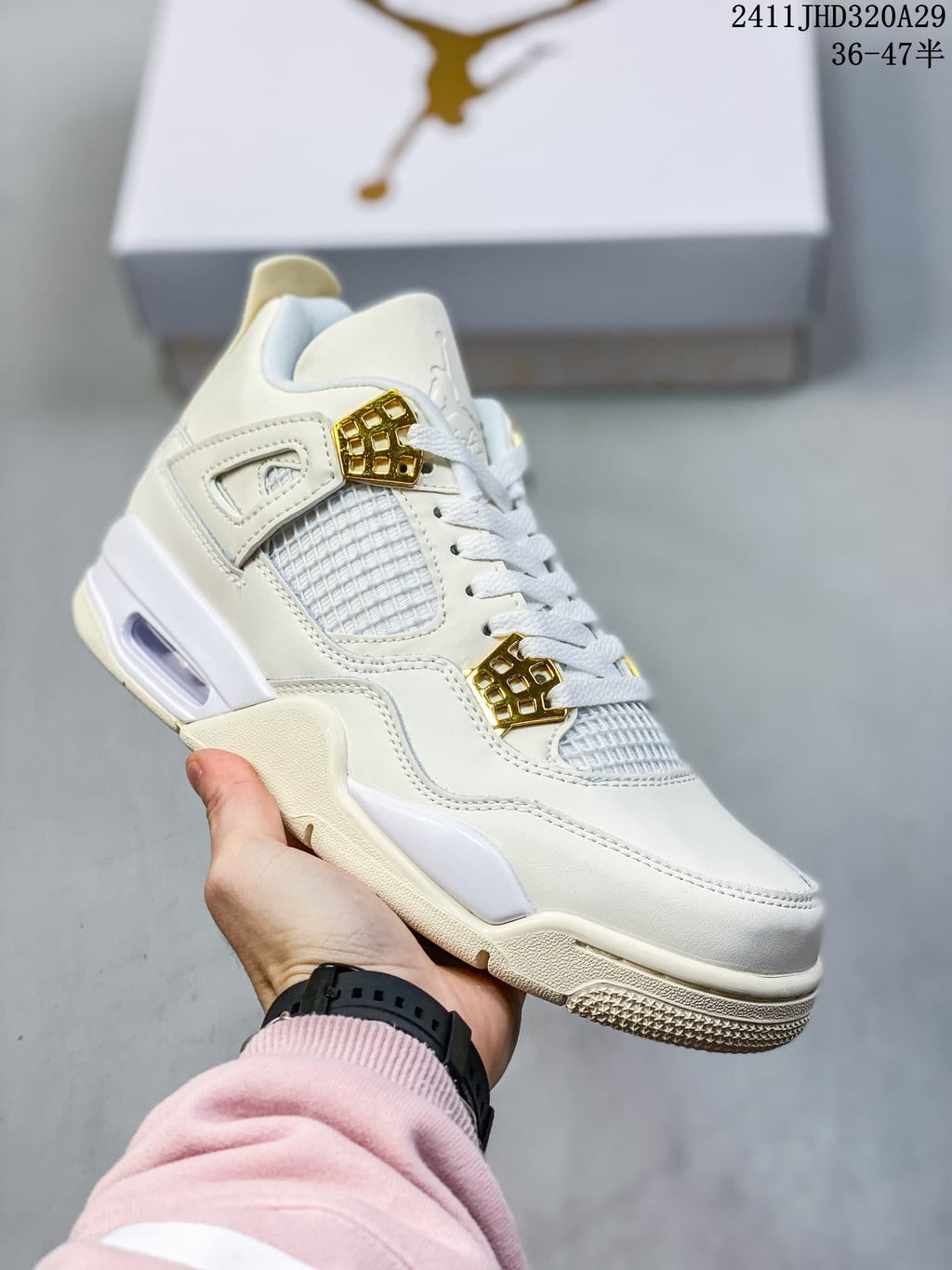 Angled side view of the white and ivory mid-top sneaker with mesh panels and gold-tone lace hardware.