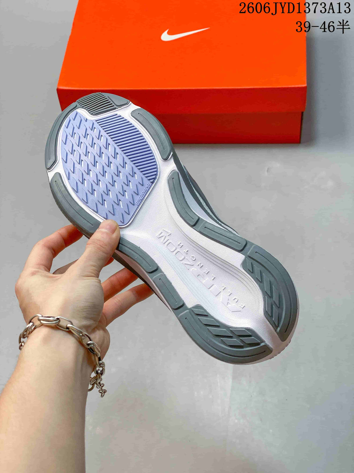Outsole view of a white Nike Pegasus 42 shoe showing its tread pattern