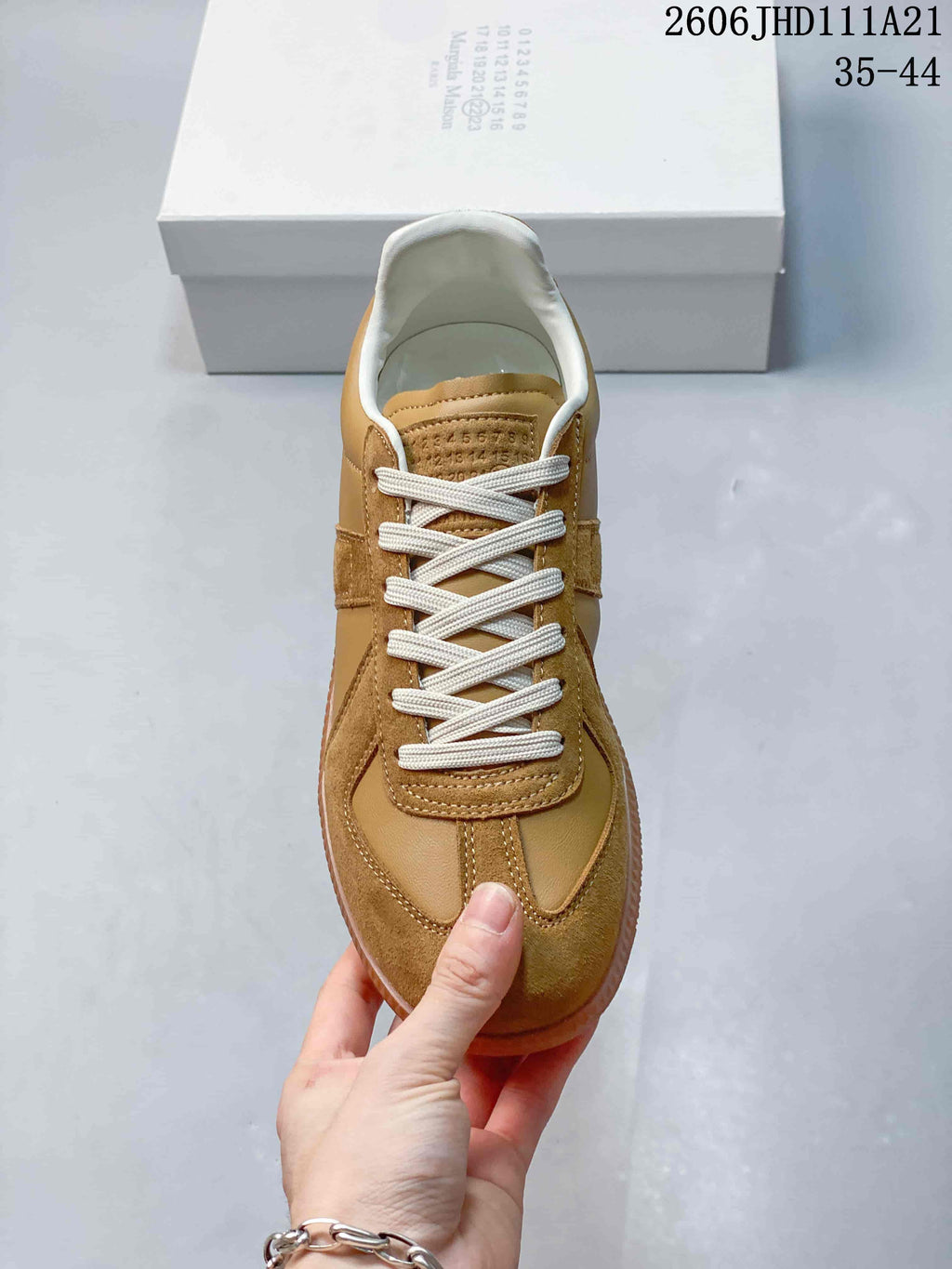 Top view showing cream laces and mixed tan panels