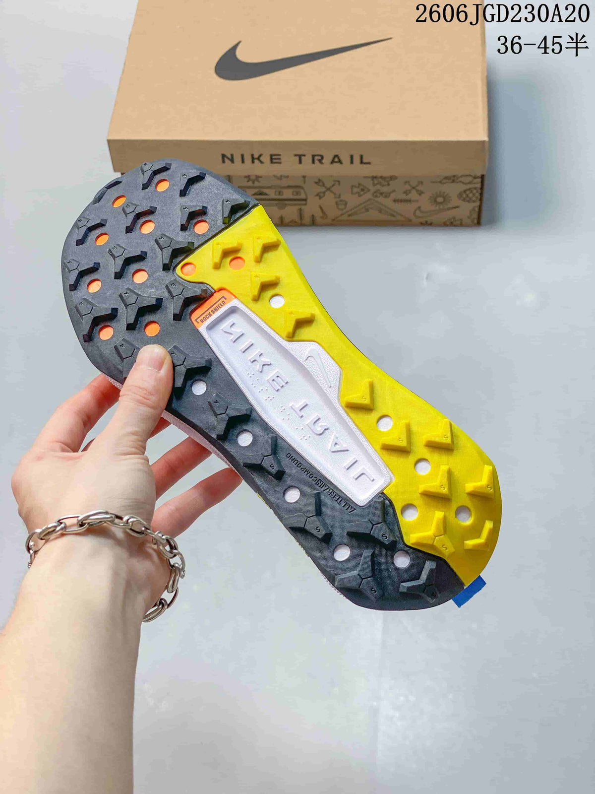 Close-up of the Nike Wildhorse 10 shoe outsole, showing dark gray and yellow tread sections.