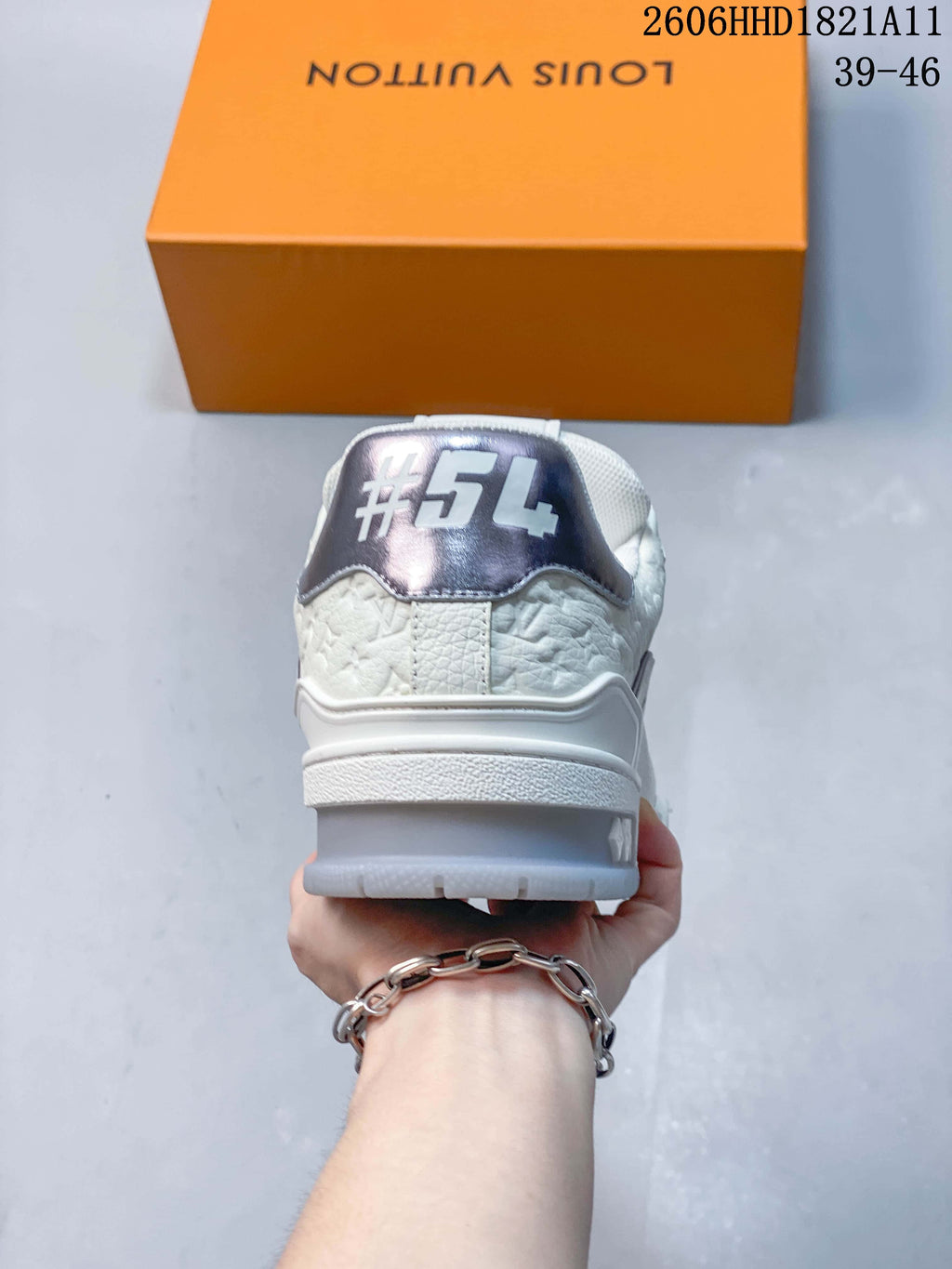 Rear view showing the metallic-tone heel panel and embossed details.
