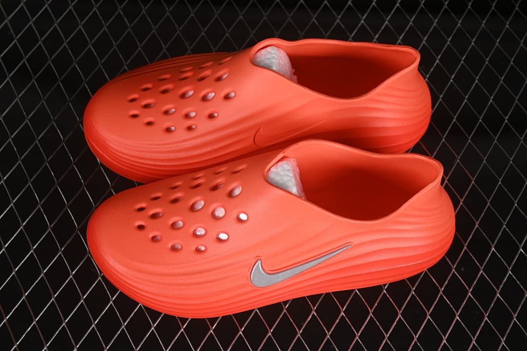Pair of orange clog sandals shown from the side