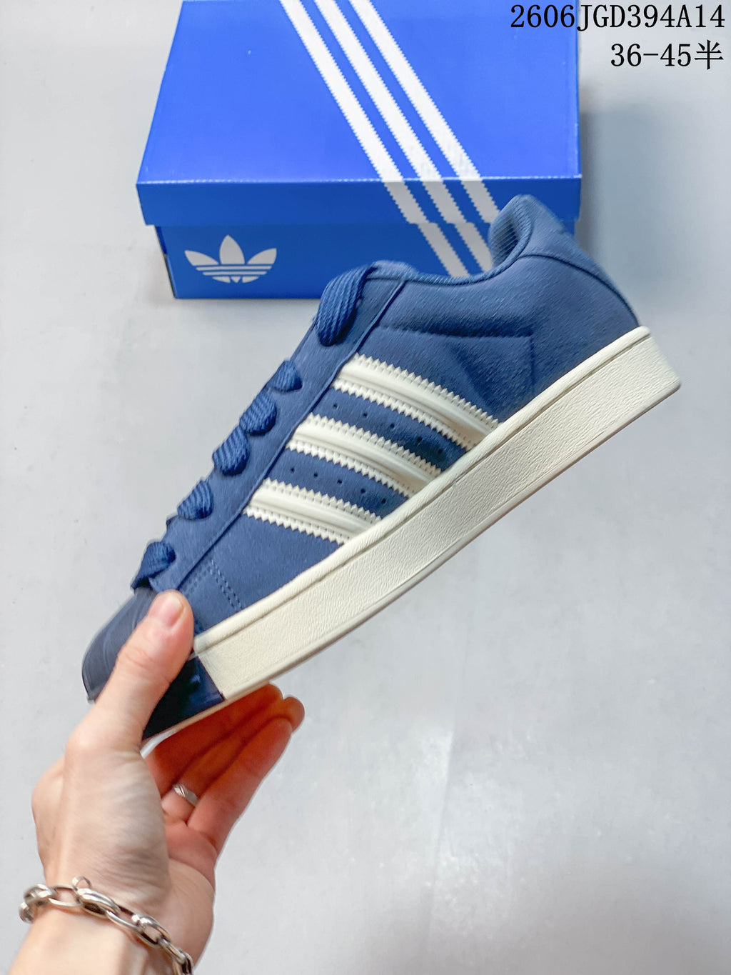 Side profile of the blue sneaker with off-white three-stripe details