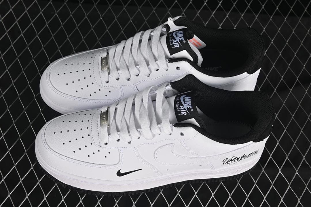Pair of white and black low-top sneakers viewed from above