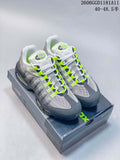 Pair of grey Nike Air Max 95 OG sneakers with white mesh and volt accents, shown on the shoebox.