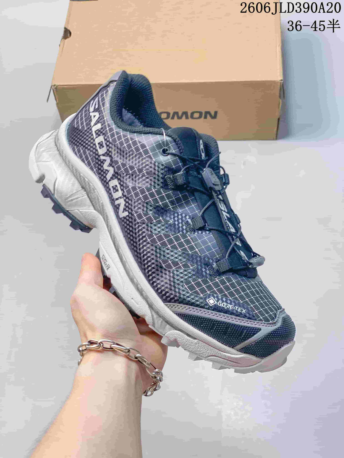 Angled view of the shoe showing its patterned upper, side branding and Gore-Tex marking.
