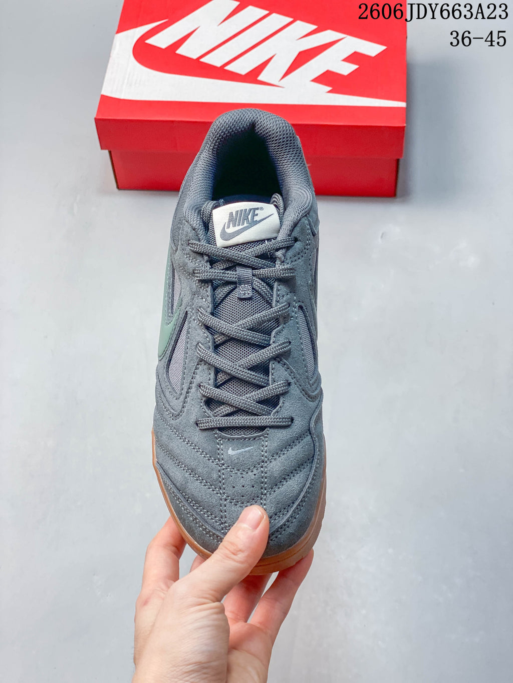 Top view of a gray Nike Gato sneaker showing its laces and layered upper