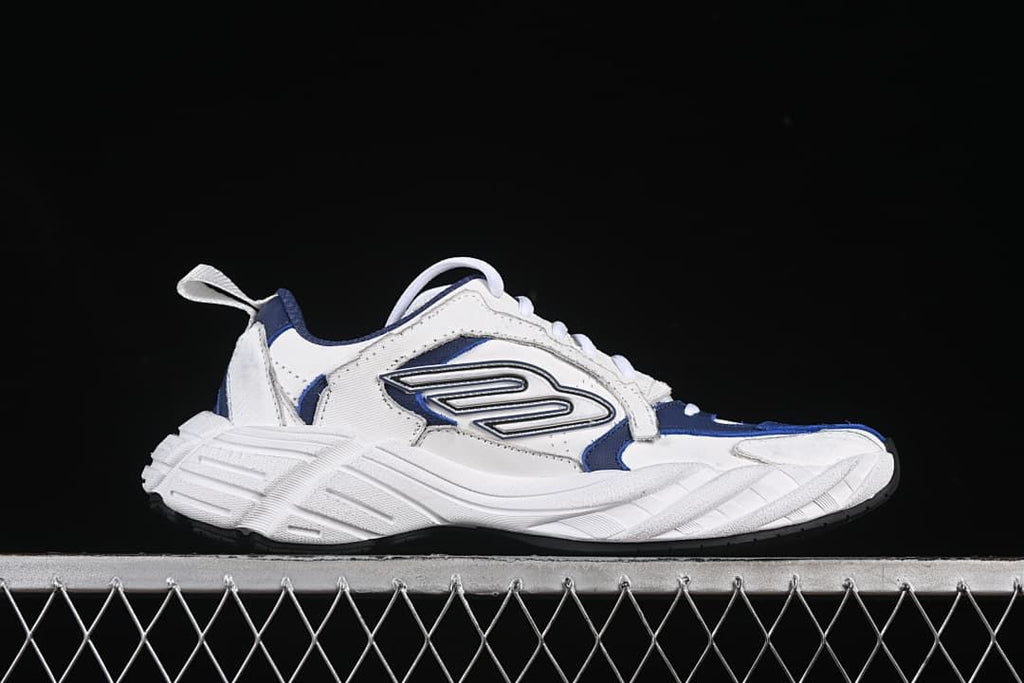 Side profile of a white and navy low-top sneaker.