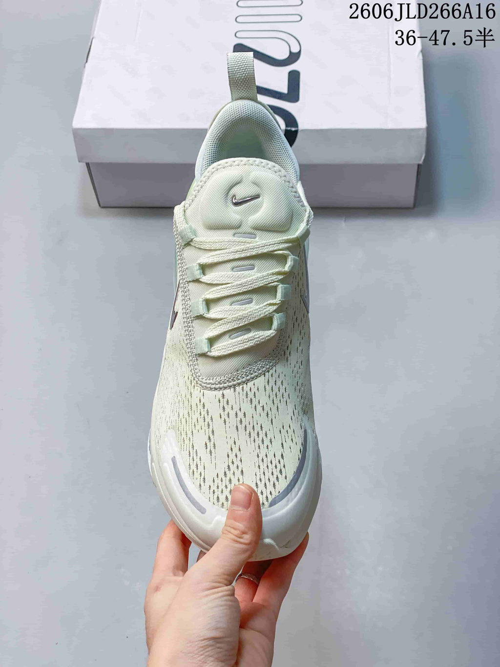 Front view of a pale green Nike Air Max 270 sneaker