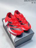 Red and black adidas Adizero Prime X3 running shoes displayed on a shoebox.