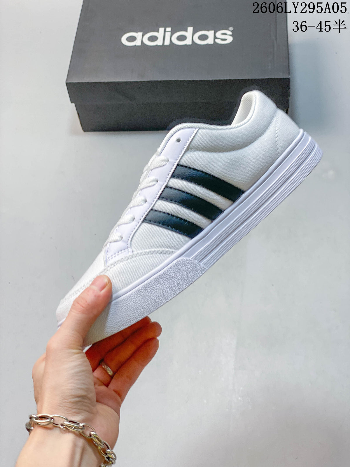 Side profile of the white sneaker with dark three-stripe detailing