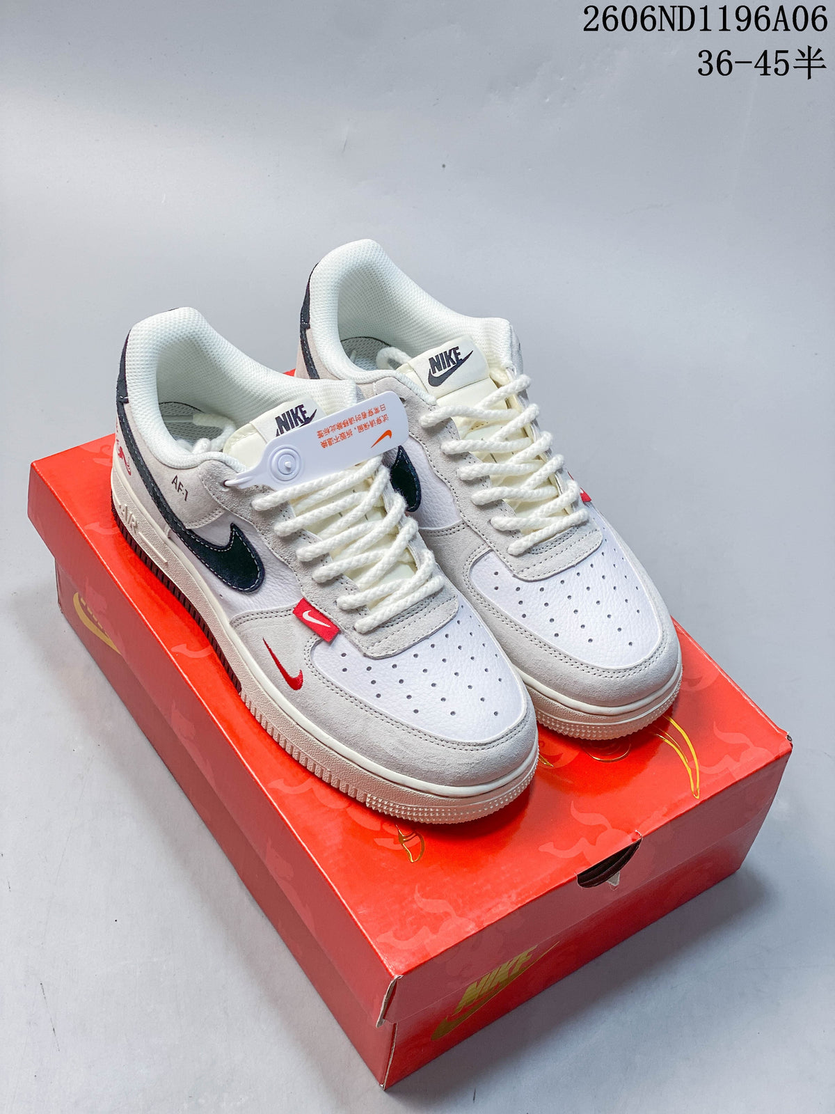Pair of off-white low-top sneakers with dark accents and red detailing on a red box