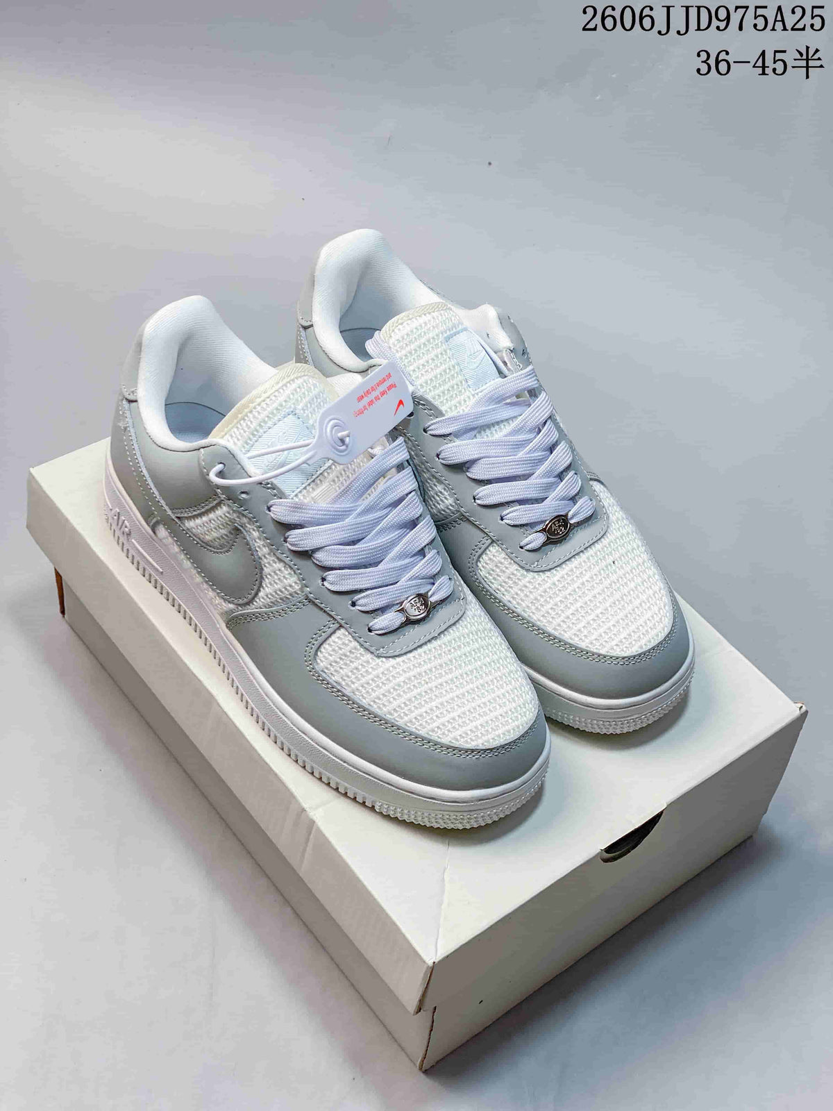 Light gray and white low-top sneakers with woven-look panels