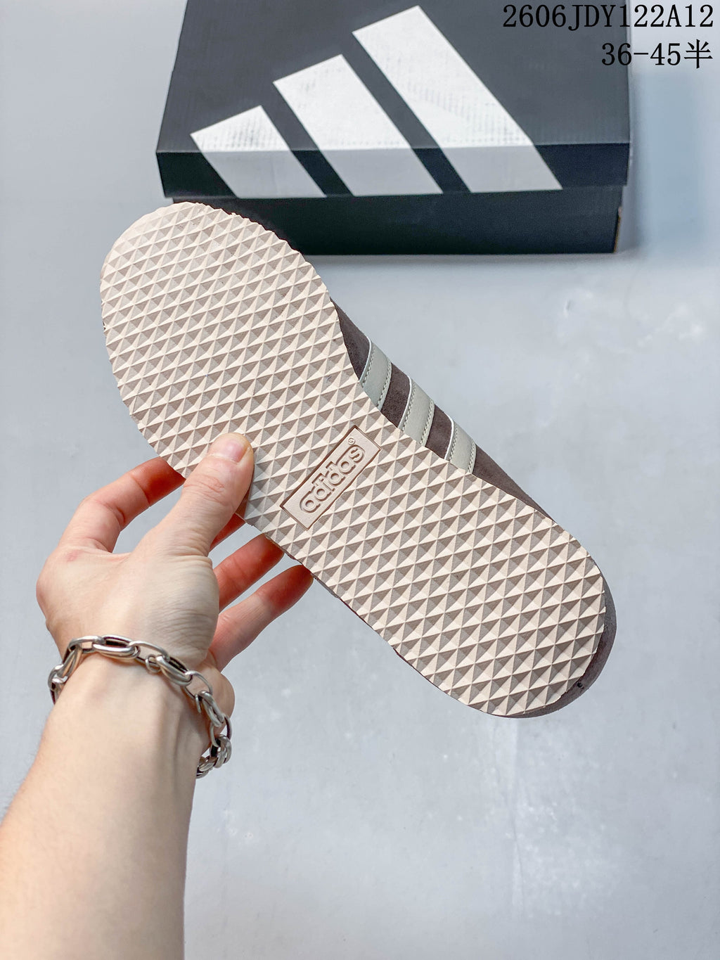 Close-up of the patterned outsole on a brown and cream sneaker