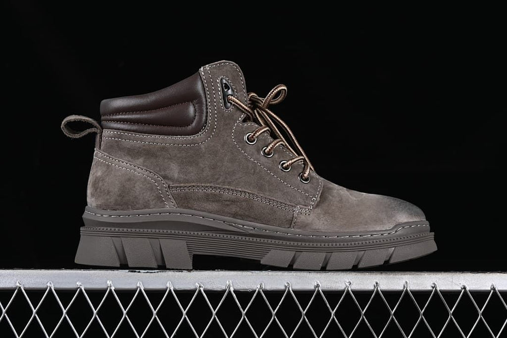 Side profile of a brown mid-top lace-up boot with chunky outsole