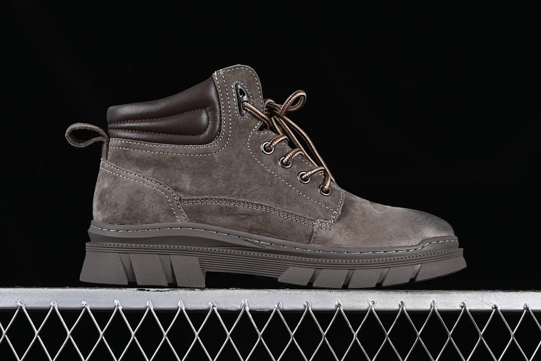 Side profile of a brown mid-top lace-up boot with chunky outsole