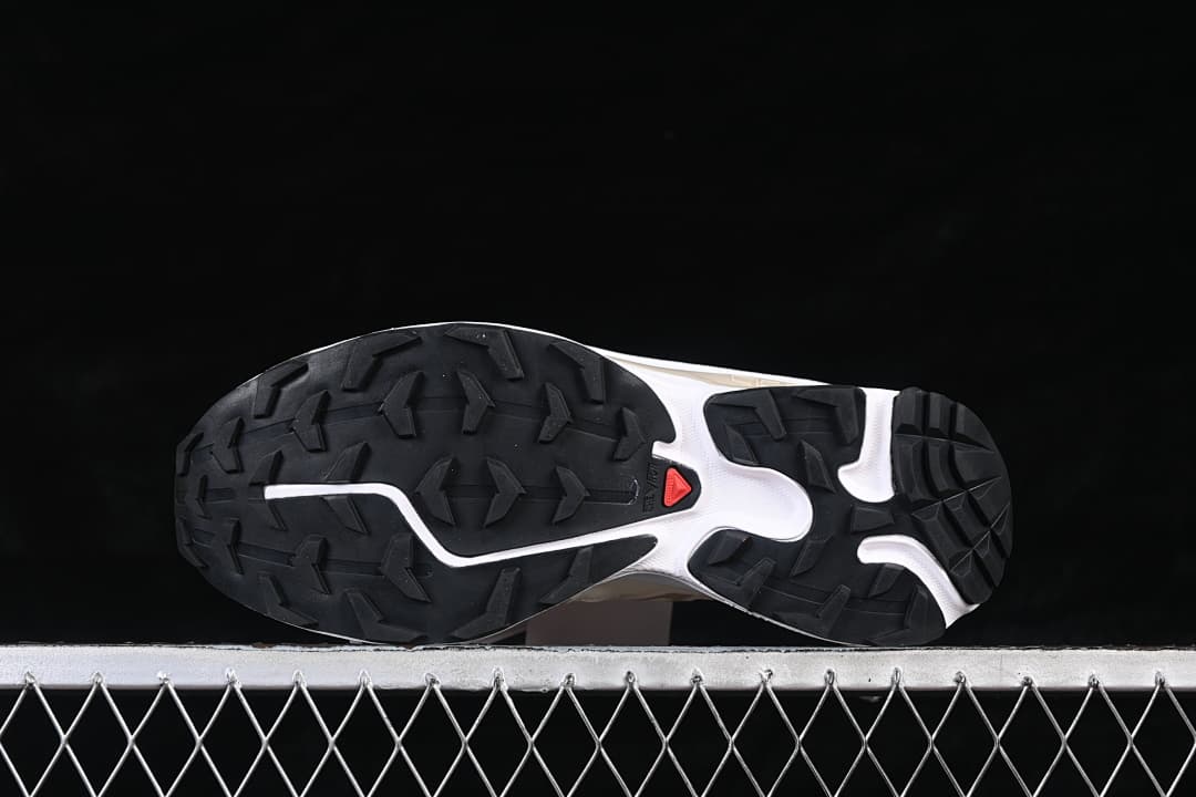Underside of the Salomon XT-6 Expanse sneaker showing a black lugged outsole.