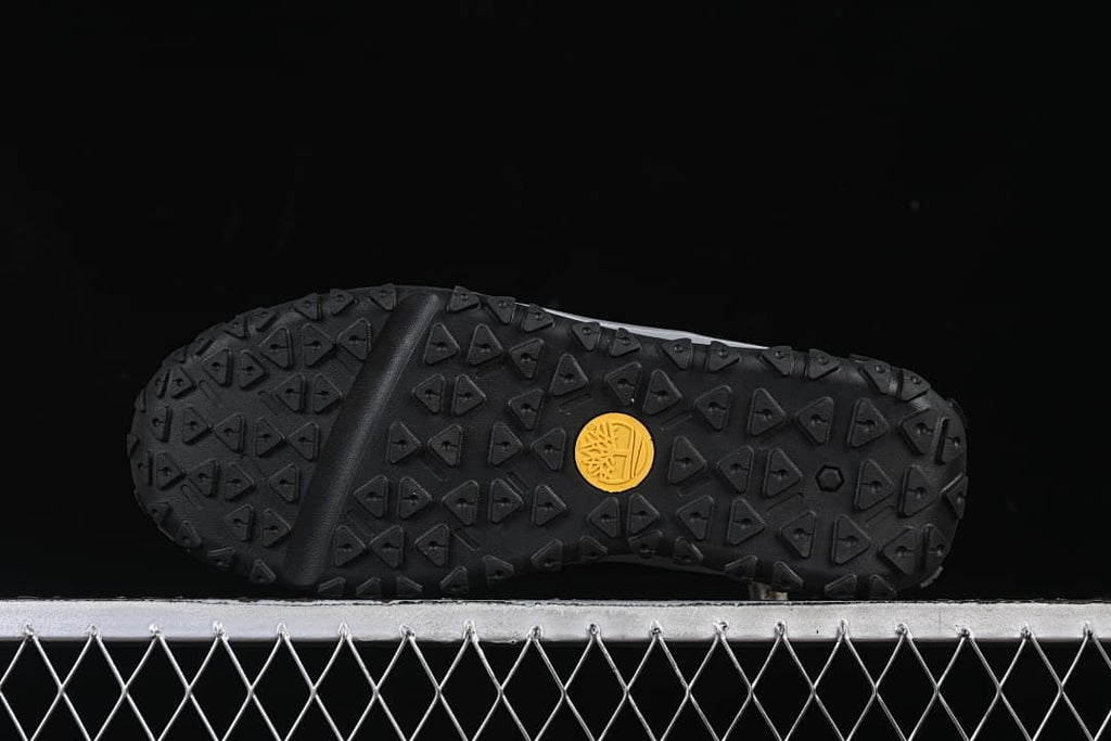Underside view showing the outsole’s geometric tread and circular logo detail.