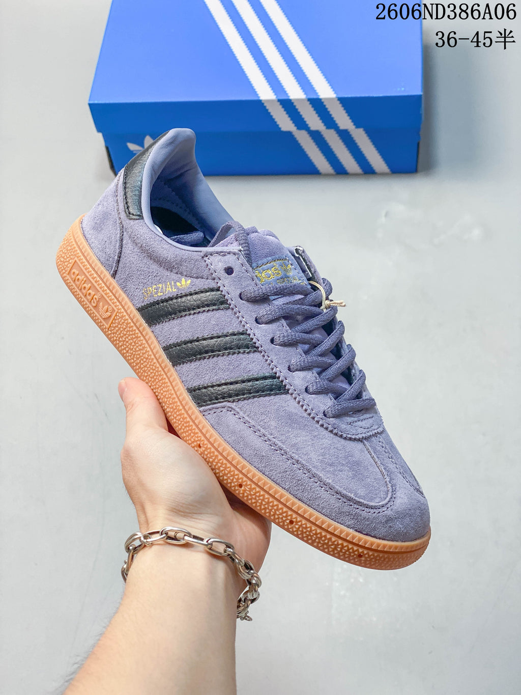 Lavender Adidas Handball Spezial sneaker with three dark side stripes and gum-colored outsole