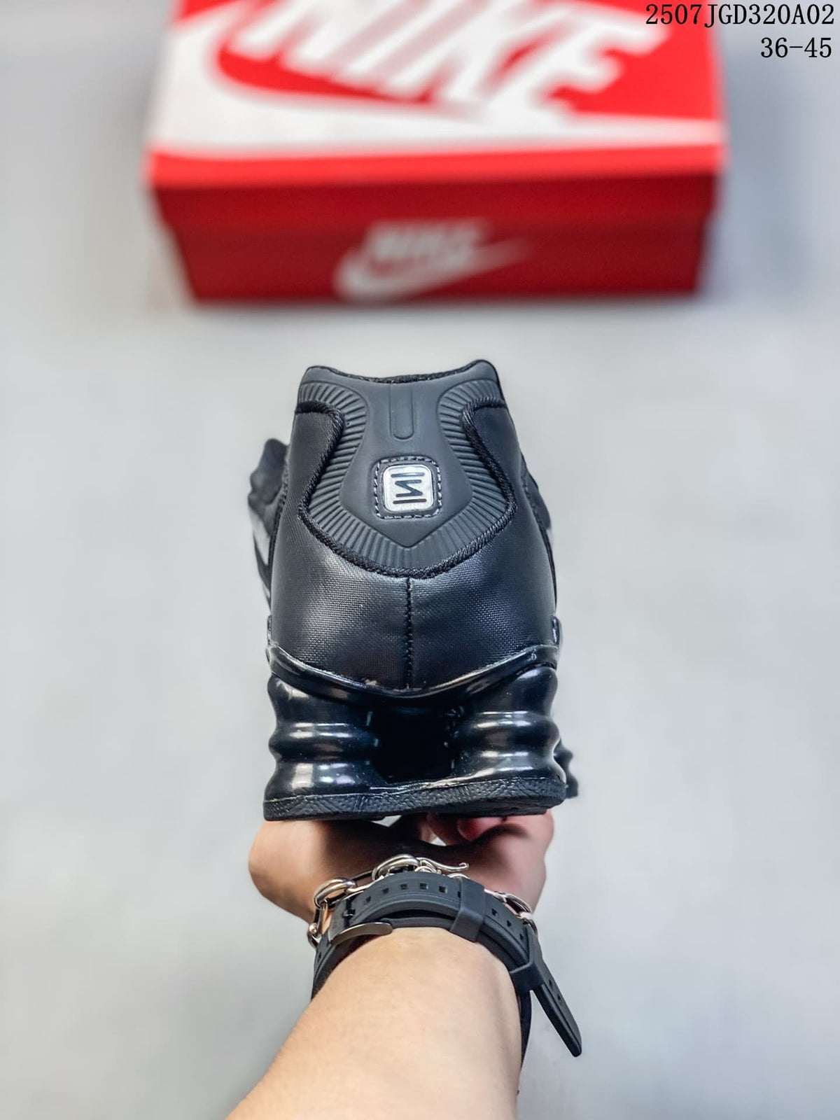 Rear view of a black sneaker with column-shaped sole details