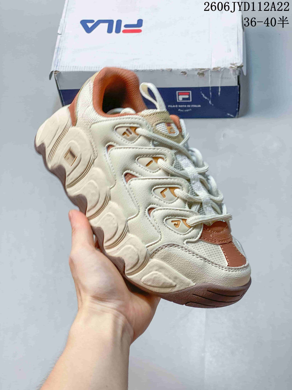 Angled side view of the cream and rust chunky sneaker