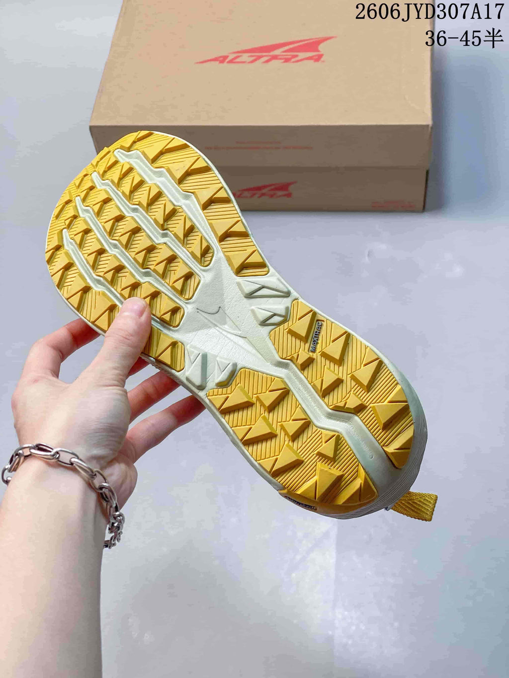 Close-up of the shoe's yellow-and-cream patterned outsole.