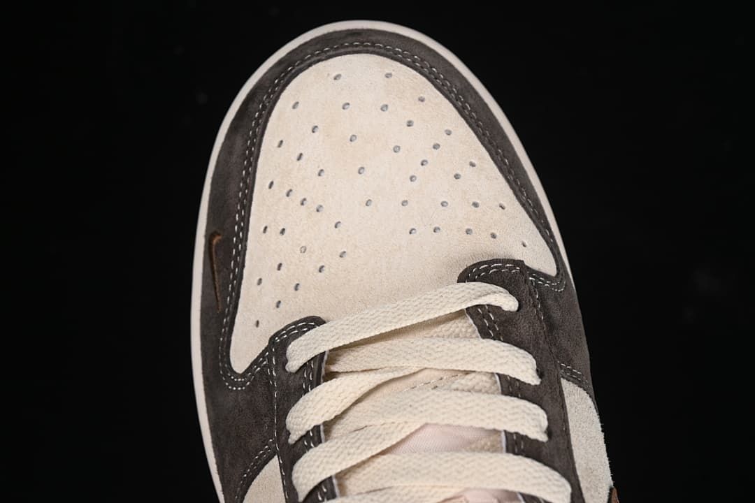 Top view of the perforated beige toe box and cream laces.
