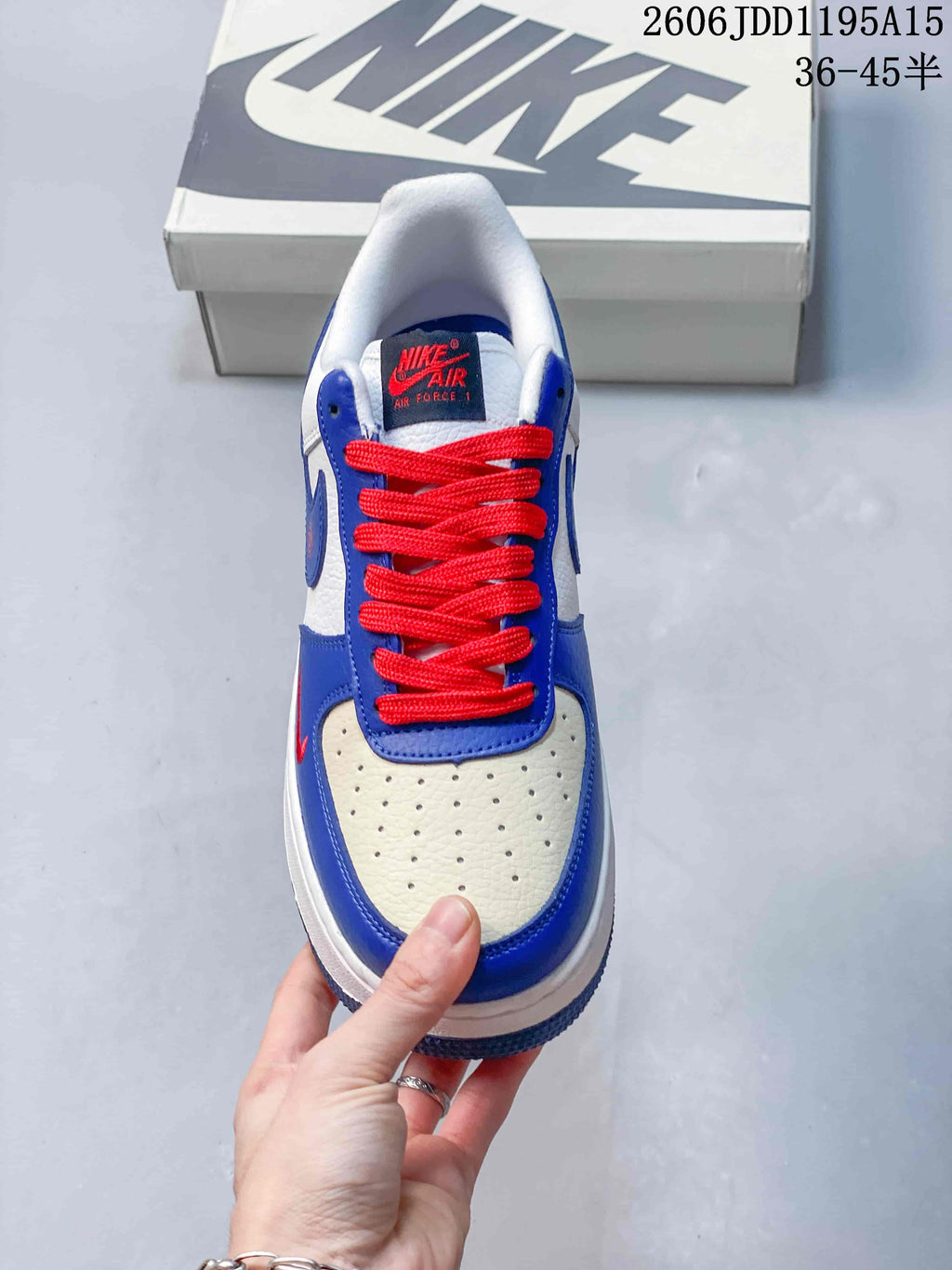 Top view of a Nike Air Force 1 Low showing red laces and a perforated toe panel