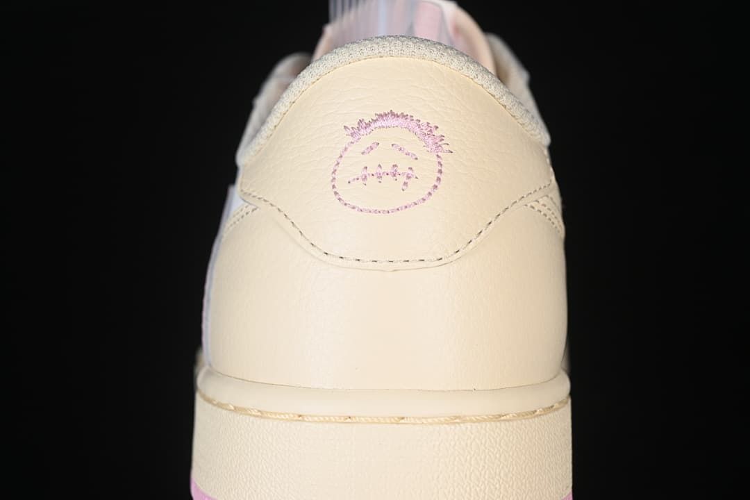 Close-up of the cream heel tab with embroidered graphic