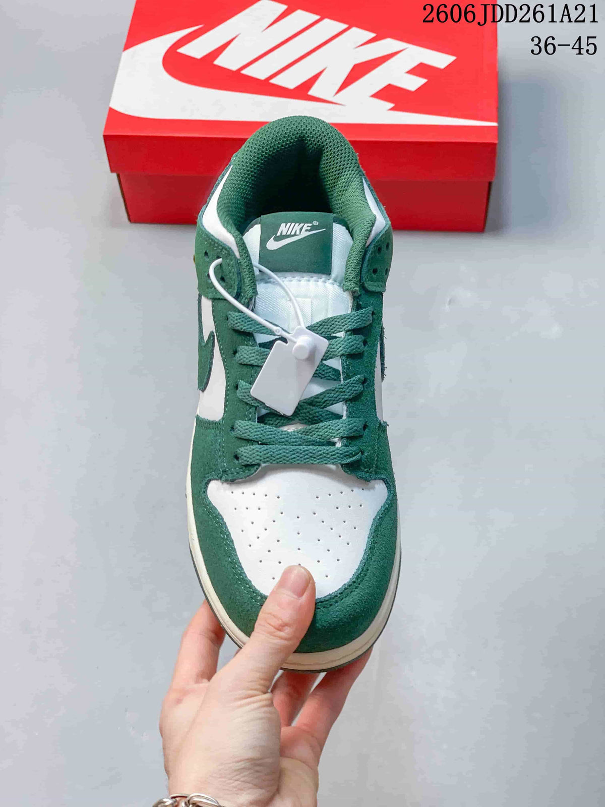 Front view of a green and white Nike Dunk Low sneaker
