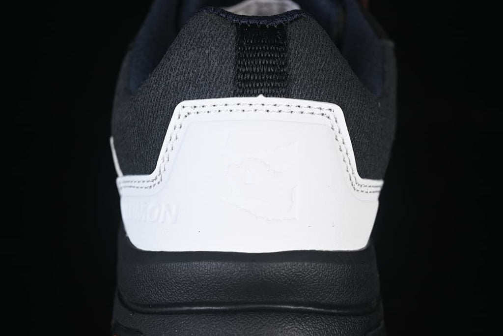 Rear view of the shoe showing its white heel panel and dark padded collar.