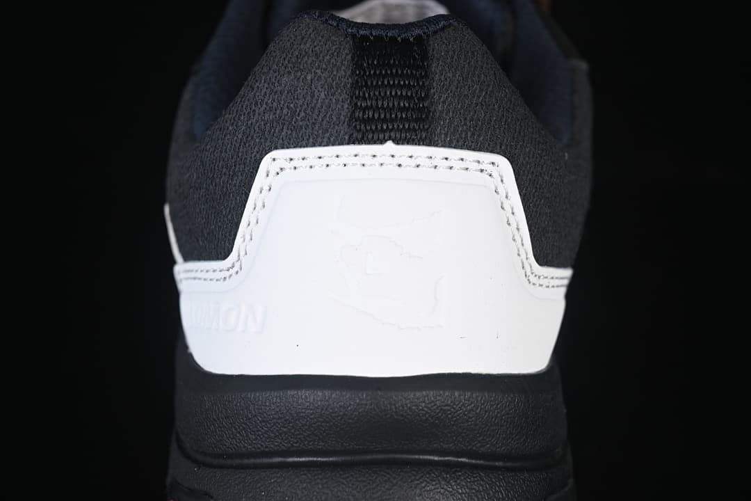 Rear view of the shoe showing its white heel panel and dark padded collar.
