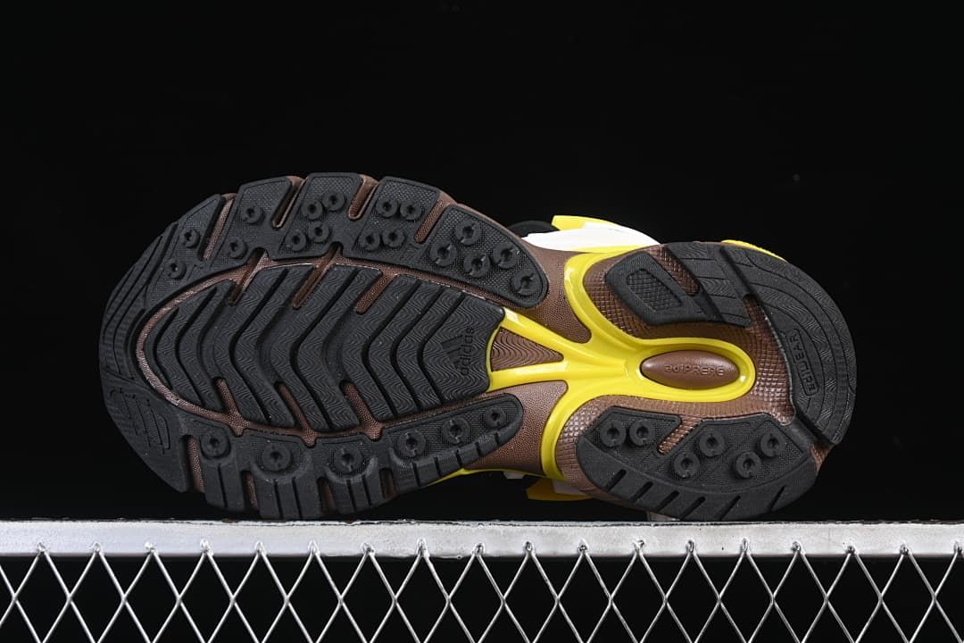 Underside view showing the black patterned outsole and yellow midfoot detail