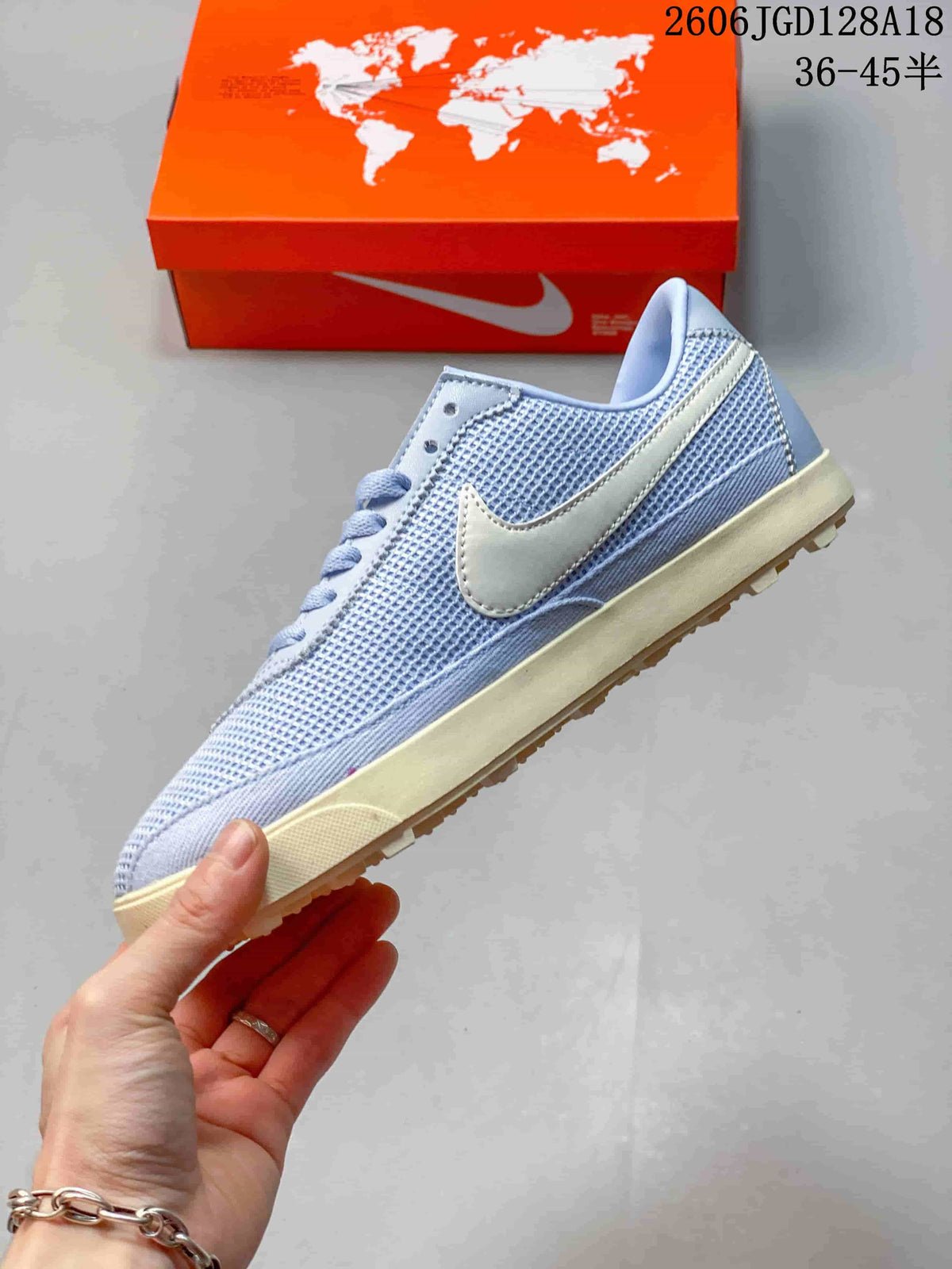 Side profile showing the mesh-look upper and pale Swoosh accent