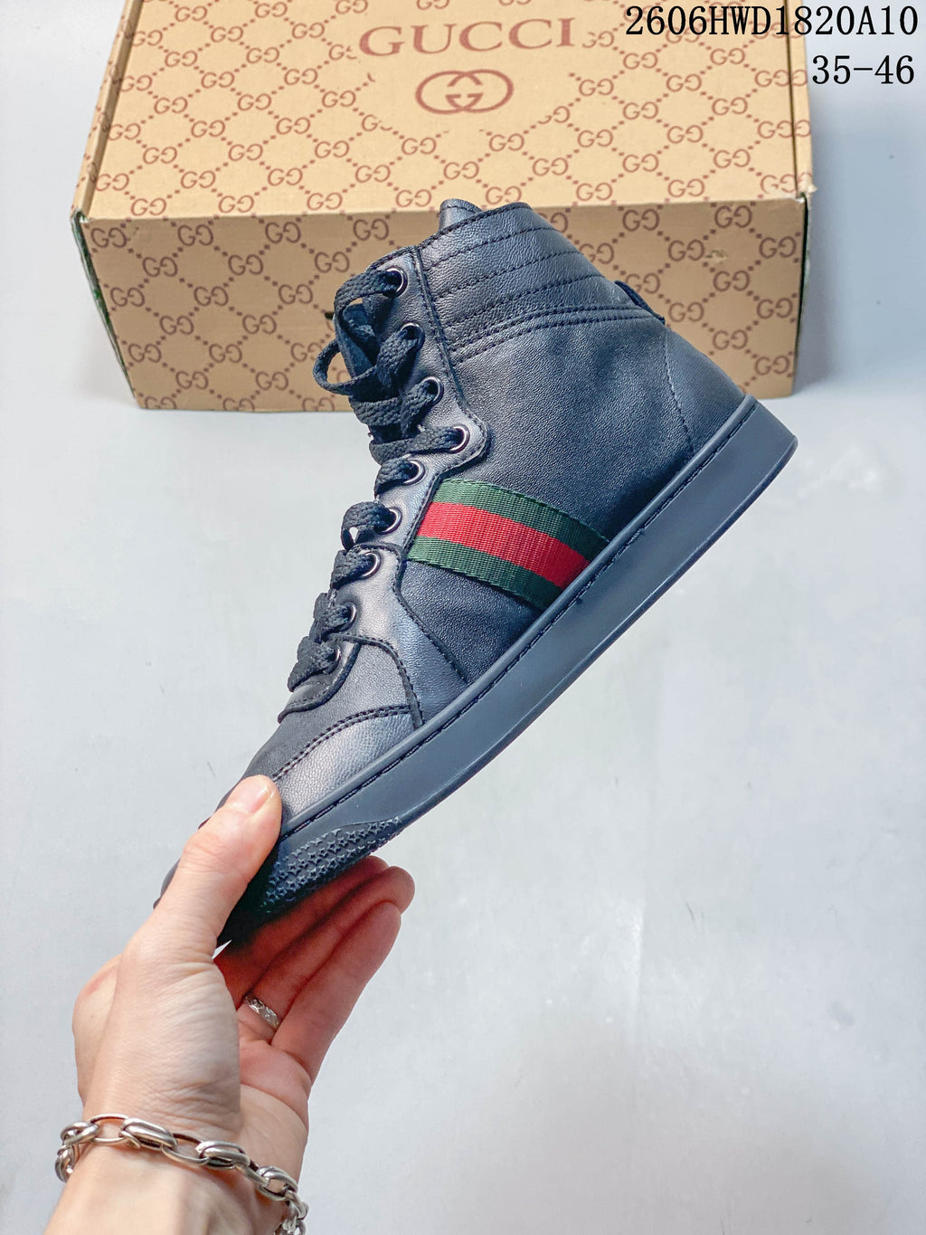 Side view of a dark gray high-top sneaker with a green-and-red stripe and tonal sole.