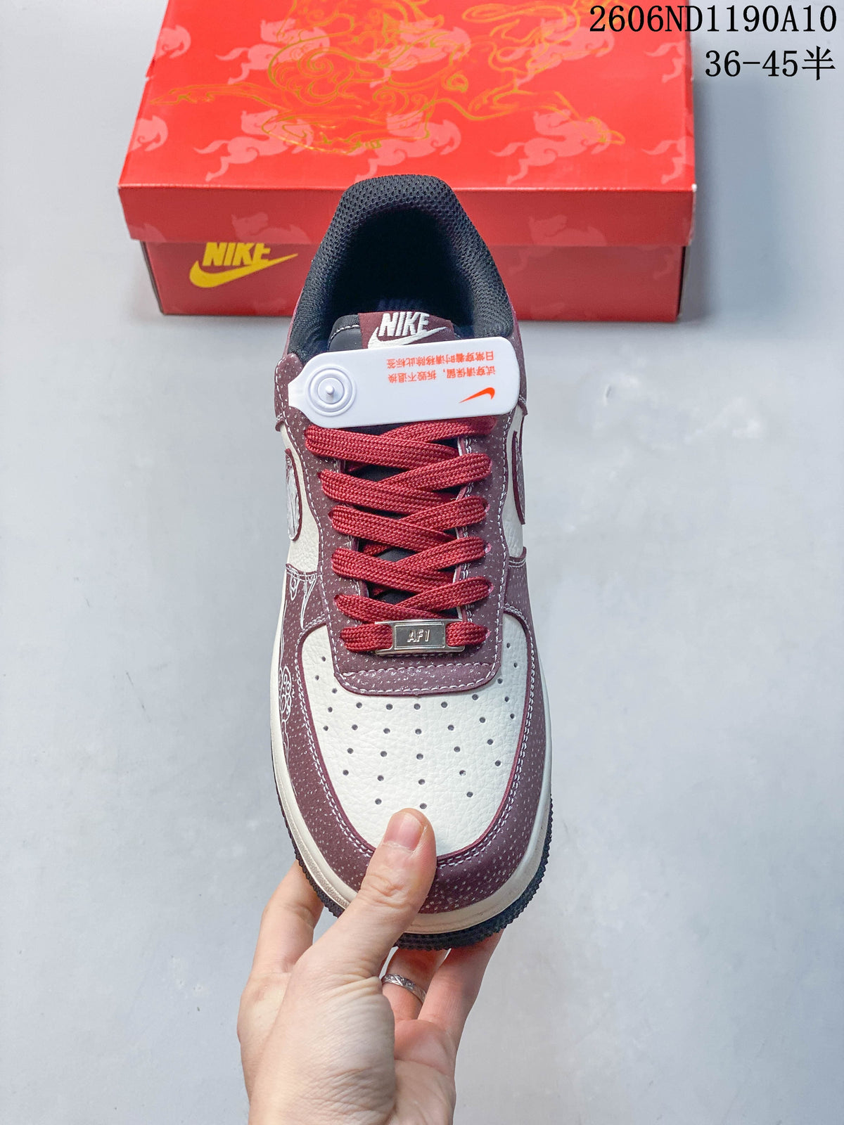 Top view showing perforated off-white toe, burgundy overlays, and red laces