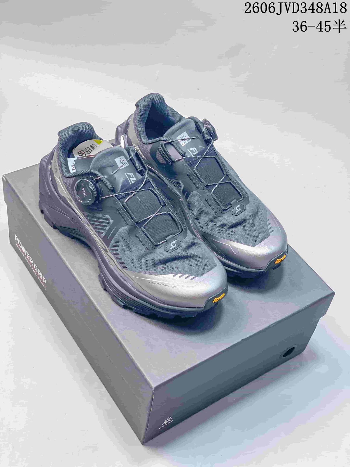Pair of gray and silver-tone KAILAS FUGA EX3 trail shoes on a shoebox.